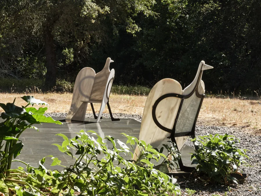 Christie's, Anthology of Design: two bird-shaped marble seats with black metal frames outdoors